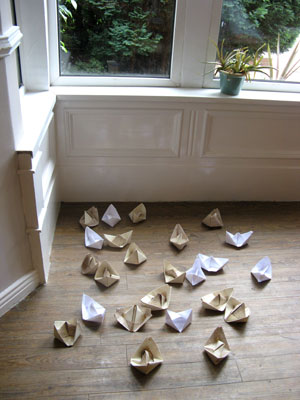 “Life Boat”(2012): origami boats installation; wallpaper, copier paper; dimensions variable